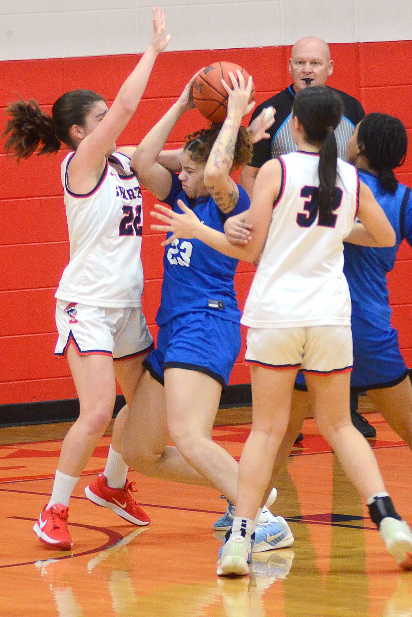 Southwestern defenders Nora Olana (left) and Jaide McPhee (32) surround DMACC's Alivia Carr during Saturday's game. McPhee scored a team-high 11 points in the 67-38 loss.