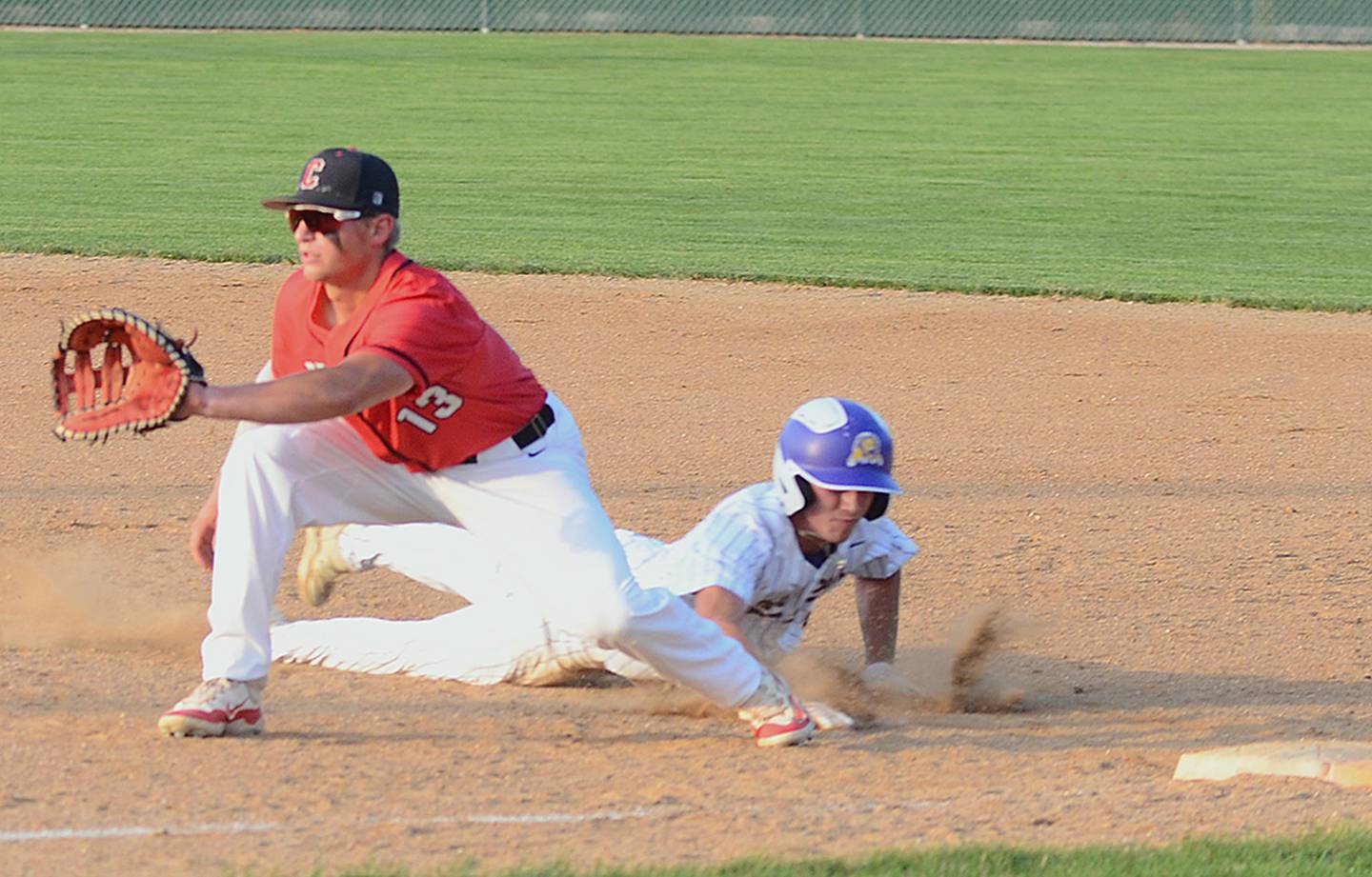 Creston first baseman Sam Henry sets up to receive a pickoff throw from catcher Milo Staver as Denison-Schleswig's baserunner scrambles back to the base. Henry had a hit and scored a run in the 10-5 Panther victory.