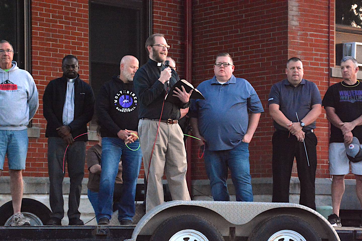 Emmanuel Lutheran Church Pastor Steven Broers leads the Greenfield Strong Gathering, surrounded by other faith leaders and community leaders.