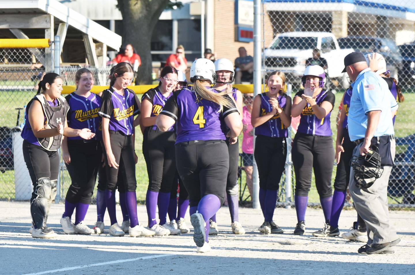 The Mustangs celebrate with Megan Henrichs after her first-inning grand slam against the Eagles Monday.