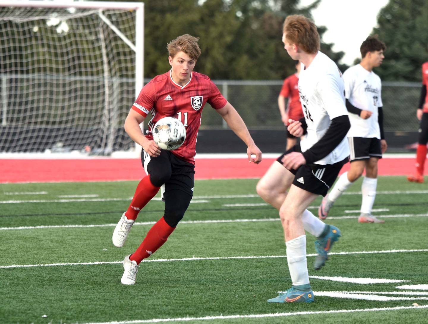 Creston senior Brennan Hayes uses a knee to stop the ball Thursday at home in a 7-2 win against Atlantic. Hayes scored a goal in the second half.