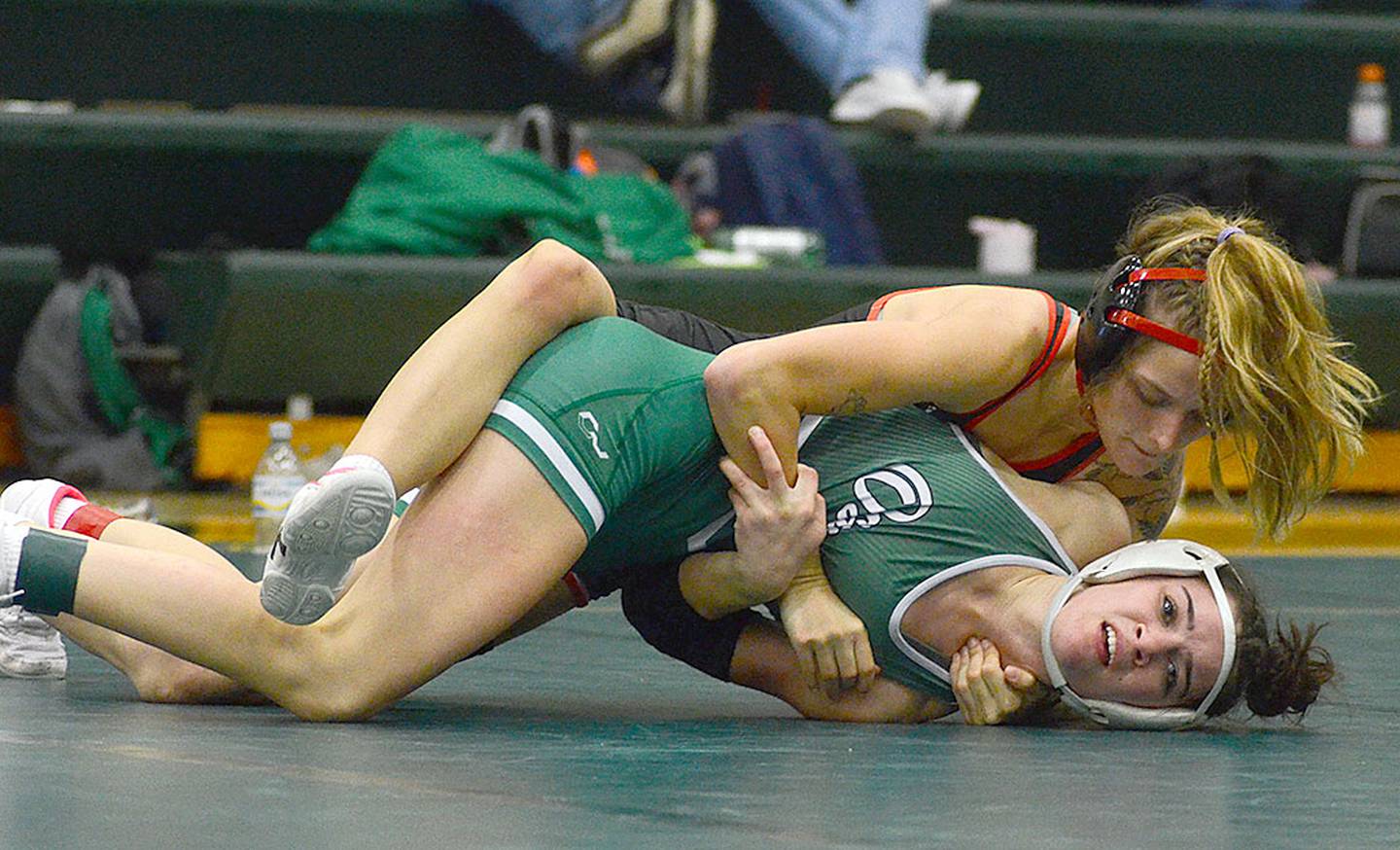 Sydney Hoffman of Creston turns Alexis Kolbet of Osage on the way to winning her 115-pound semifinal match by fall. Hoffman placed second.