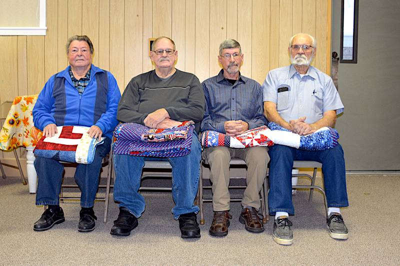 From left, Robert J. Wyllie, David Woman, Marlin Wyllie and Lee Guthrie were four veterans who received quilts from Fabric and Friends Quilt Guild Saturday, Nov. 9.