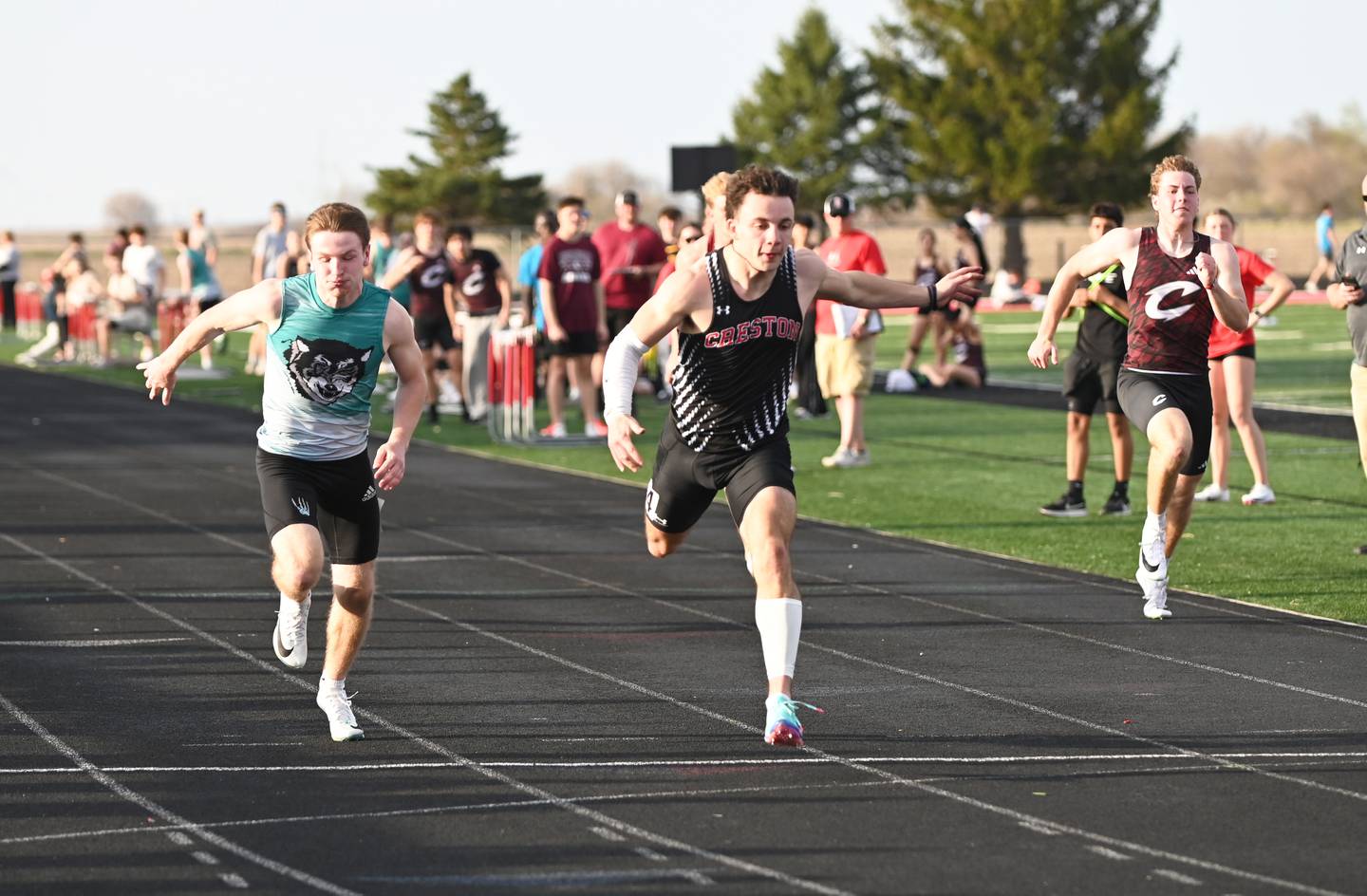 Creston senior Seth Gordon, right, crosses the finish line of the 100m dash first in 11.34. In second place was Brody Crozier, left, of Southwest Valley, who ran 11.44.