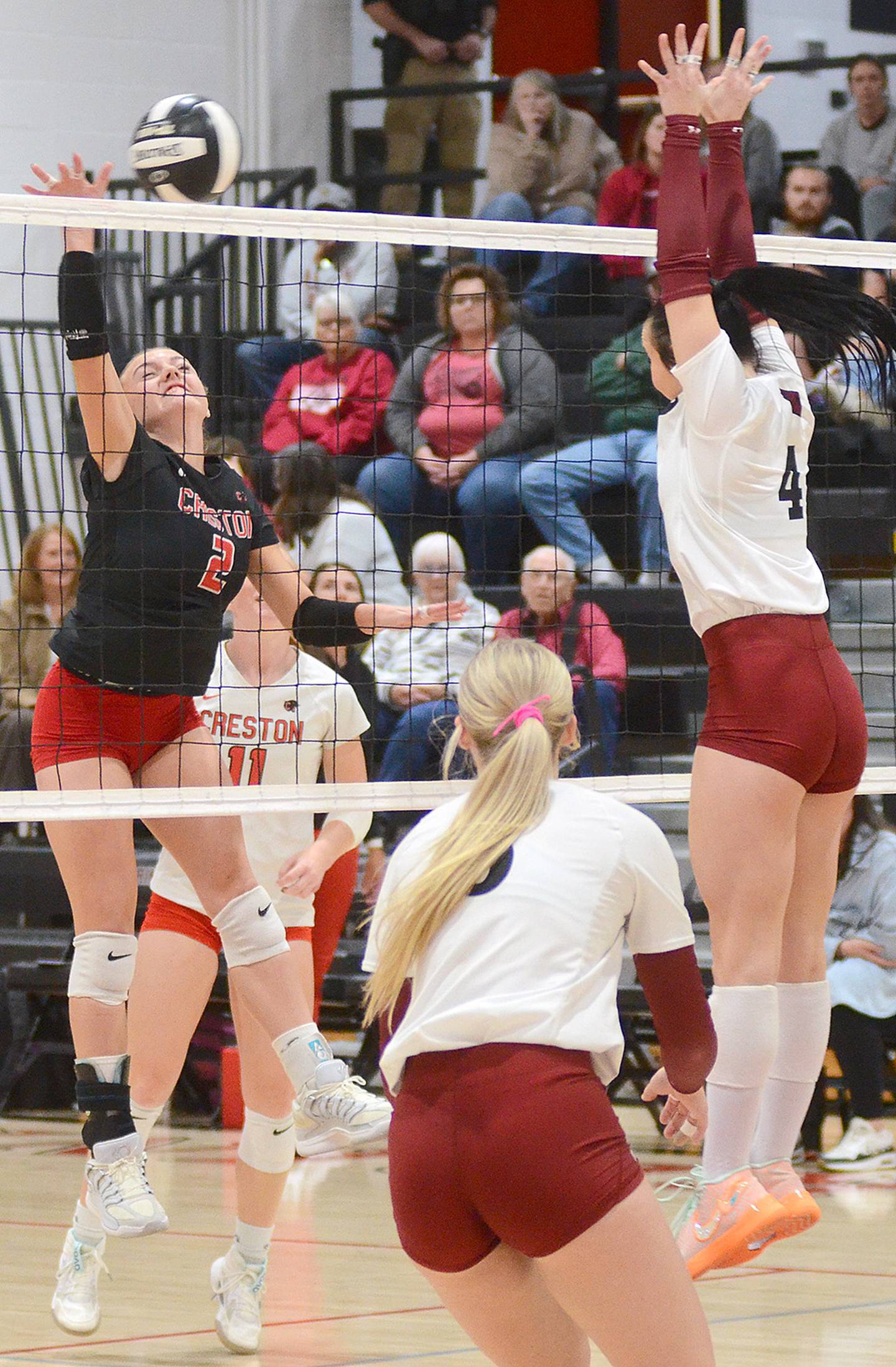 Creston's Hollynn Rieck attacks against Clarinda blocker Kylie Meier (4). Rieck had 10 kills and a team-high 25 digs in the match.