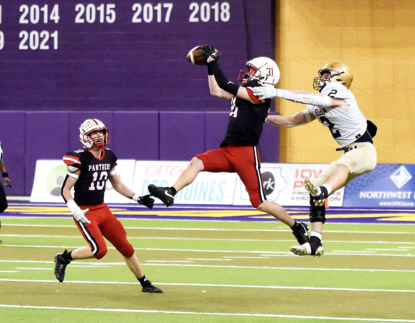 Dylan Calvin (No. 31) intercepts a pass thrown by Bishop Heelan quarterback Quinn Olson Saturday while teammate Dillon Starlin looks on. The Panthers lost 16-13 in the semifinal match. Calvin’s six interceptions this season leads Class 3A