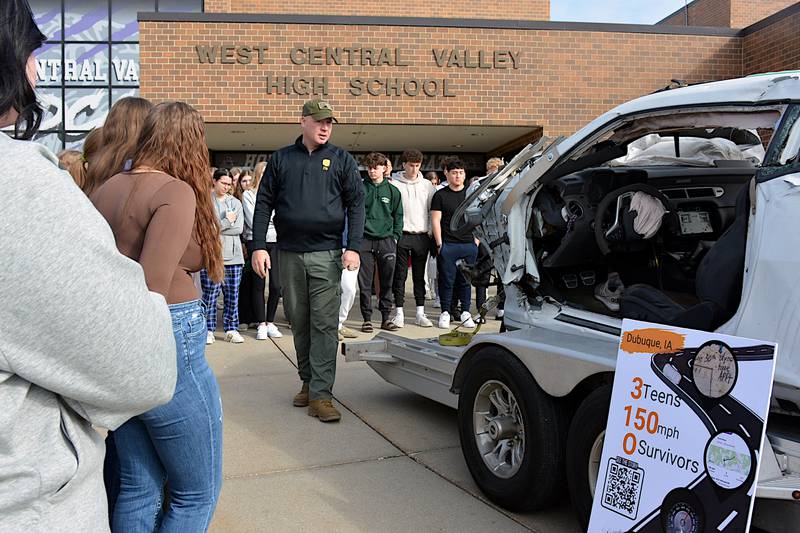 Trooper Eric Payne shows West Central Valley students the damage done by a high-speed crash in 2022 that killed three teens near Dubuque, during a presentation Monday, March 31 at the Stuart school.