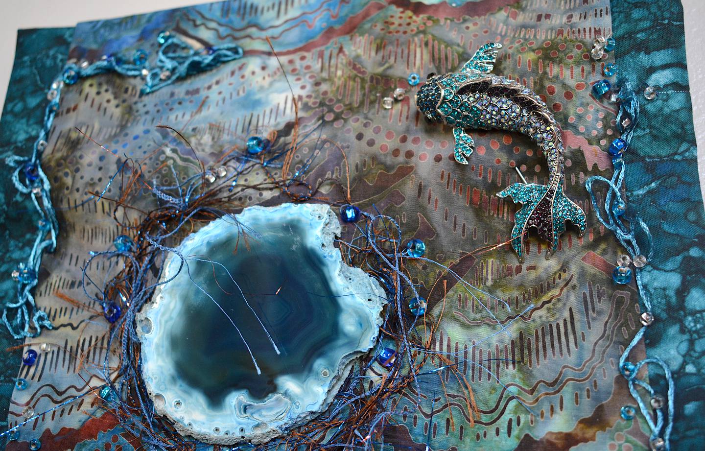 An intricate design using materials not seen in traditional quiltmaking to create a patterned scene.