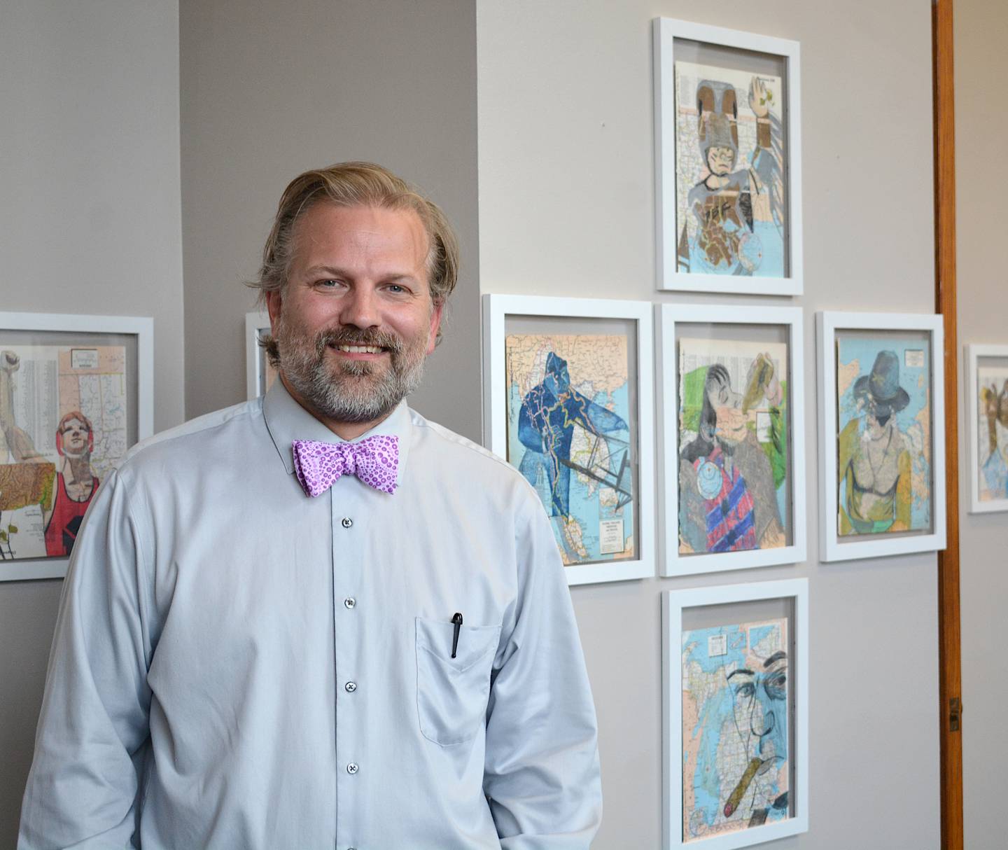 Mr. Burgher alongside a few of his works. His exhibit will be shown through the month of July at the Creston Arts Depot Gallery.