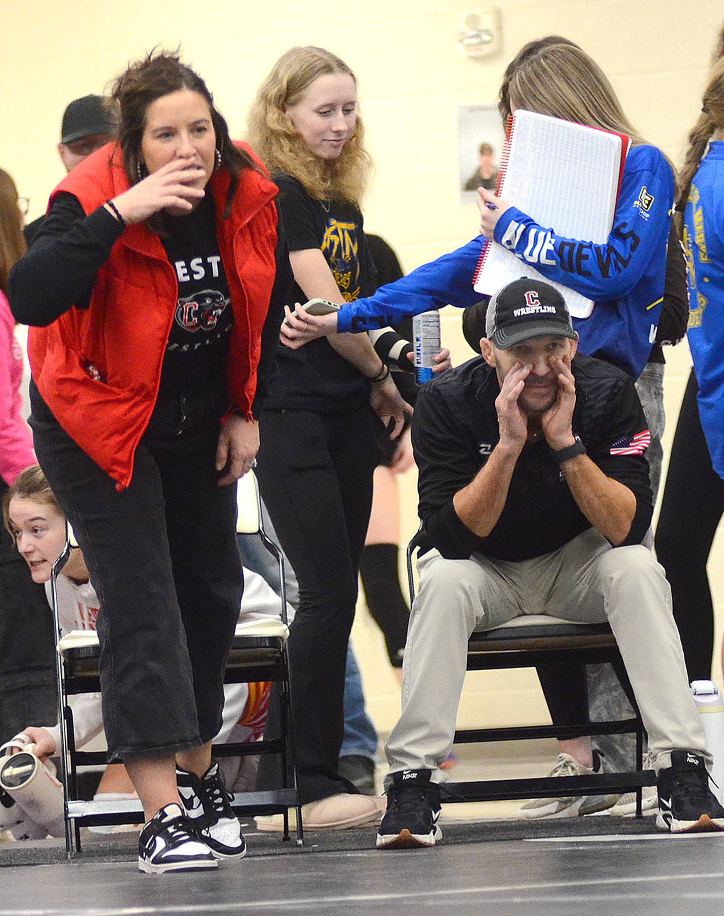 Creston head coach Maggie Arnold (left) and assistant Mario Galanakis shout encouragement to Panther wrestler Christina Strand during a match Saturday.