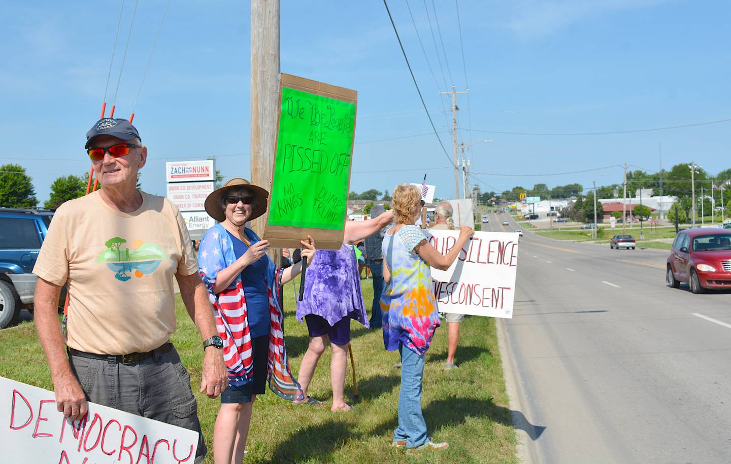 For some protesters, creating a sign was as easy as writing on cardboard and taping it to a stick. These flashy signs would often get honks from motorists.