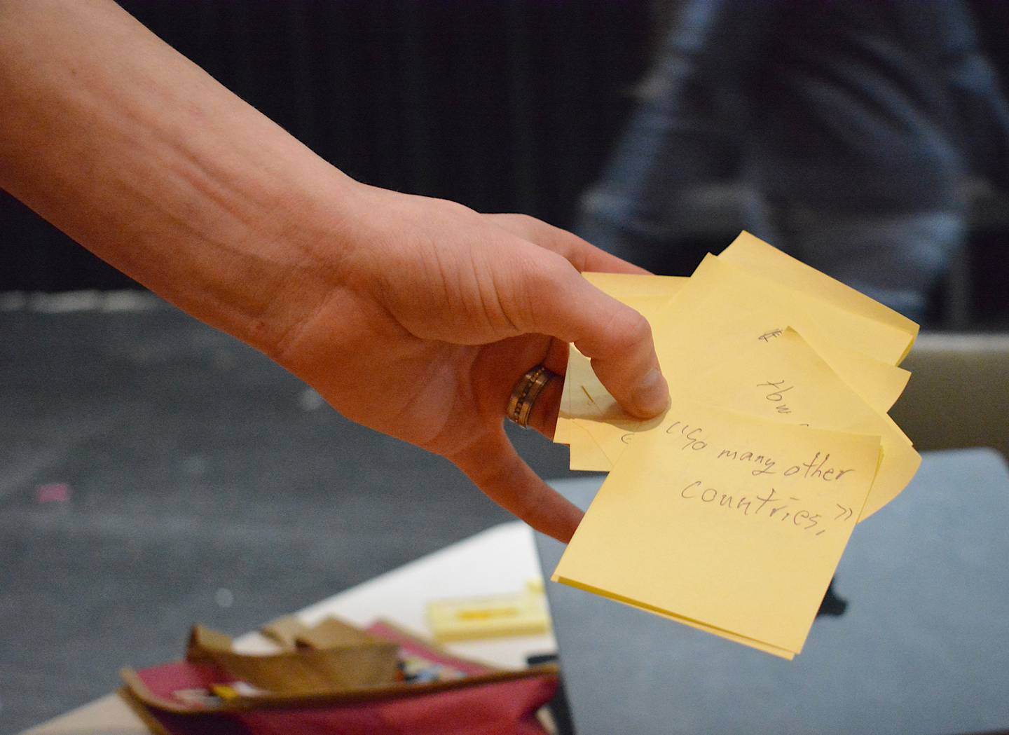 Sticky notes with messages passed between the debate team. While another team is speaking, students have to quickly come up with counter-arguments and rebuttals without openly speaking with their partner.