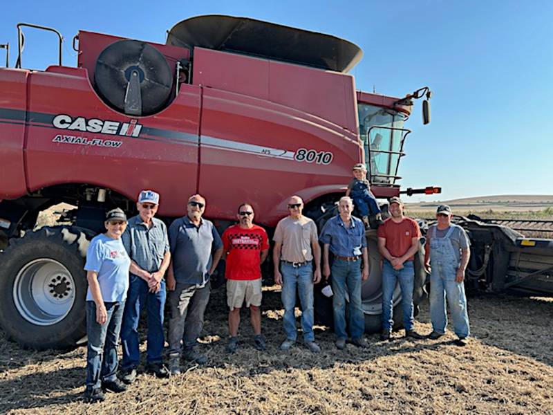 Helping with Fields of Faith Oct. 4 were from left, Marilyn Jensen, Rolan Jensen, Dave Harris, Don Hume, Dennis Lundy, Wendell Zimmerman, Charlie Christoffersen (on combine tire), Michael Christoffersen, Randy Christoffersen. Not pictured are Chad Winkelmann and Pastor Melinda Stonebraker.