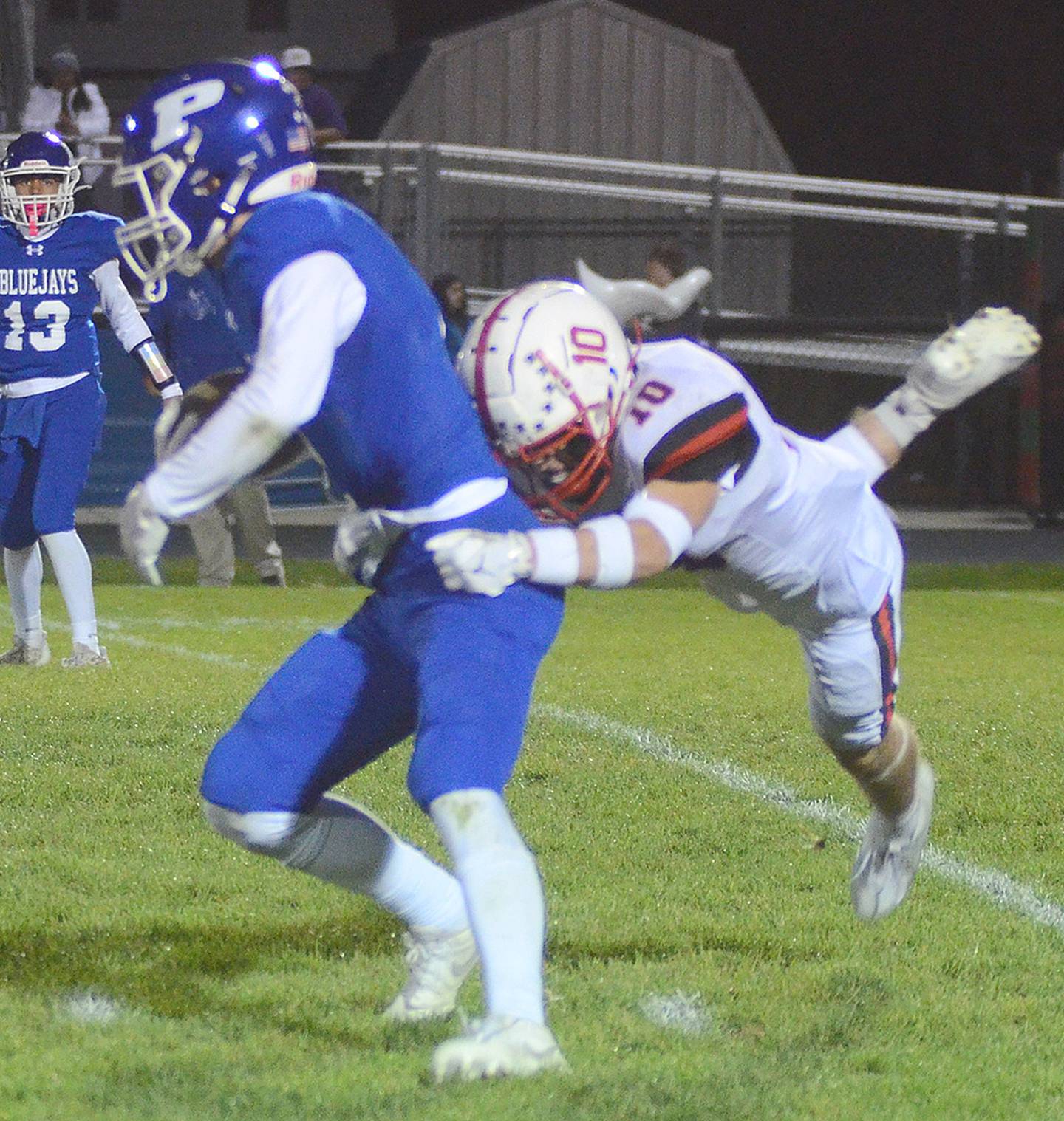 Coltyr Frey of Creston (10) makes a leaping tackle of Perry's Ryan Modlin after a pass reception. Frey had 3.5 tackles, including two solo stops.