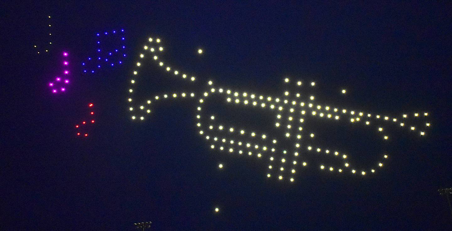 A trumpet plays some notes in the night sky.