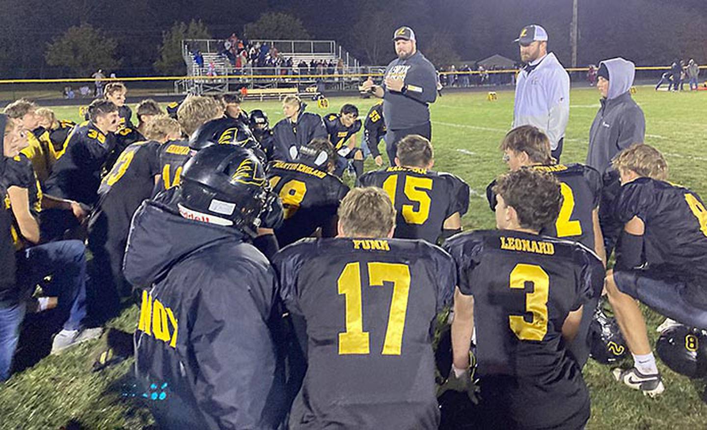 Co-coach Michael Nardini (center) and co-coach Cole Bonde address the Lenox football team after Friday's 41-6 playoff win over Ar-We-Va. The Tigers host Montezuma Thursday in the quarterfinals for a trip to the UNI-Dome for the semifinals.