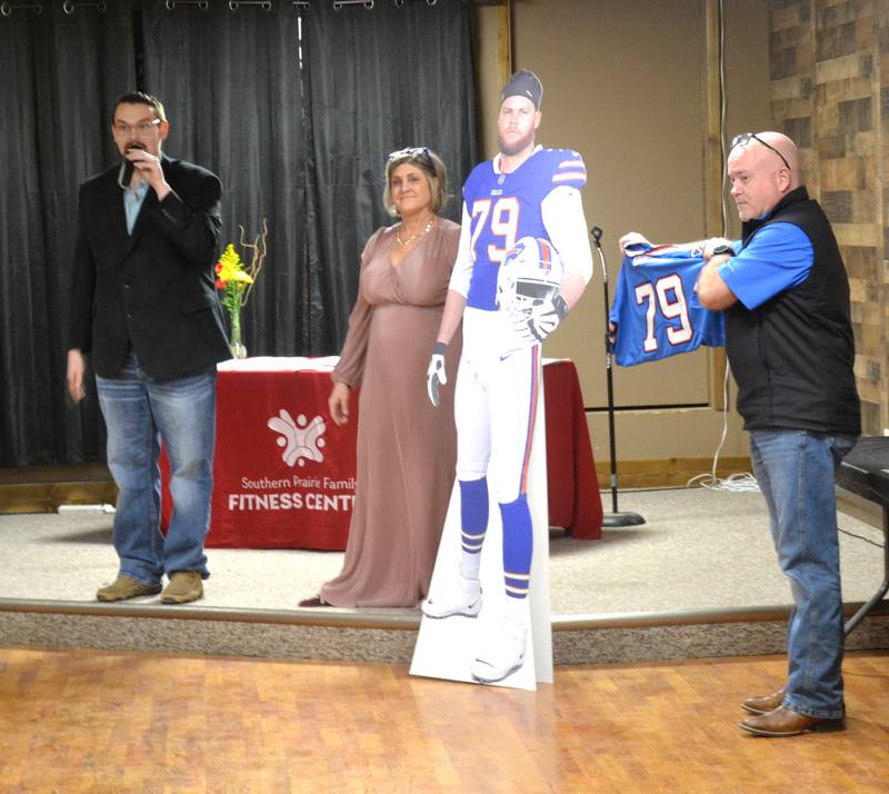 Two items donated by Lenox-native Spencer Brown are auctioned off Saturday during SPFFC's Sweetheart Dinner. From left: Auctioneer Chantz Davidson, SPFFC Director Denise Kuhns, SPFFC Assistant Director Ben Walker.