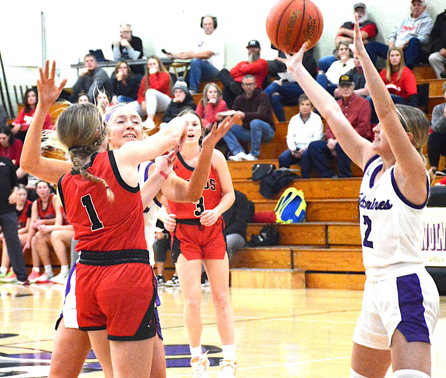 NV’s Izzy Eisbach (left) and Maddie Weston (2) trap Treynor sophomore Claire Schrage (1), leaving her without much of a passing lane to work with, during a top-10 battle Tuesday, Nov. 28 in what was the Wolverines’ opening game.