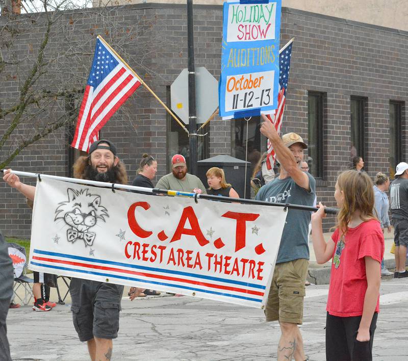 Members of Crest Area Theatre march during Saturday's Balloon Days Parade, advertising the holiday show auditions.