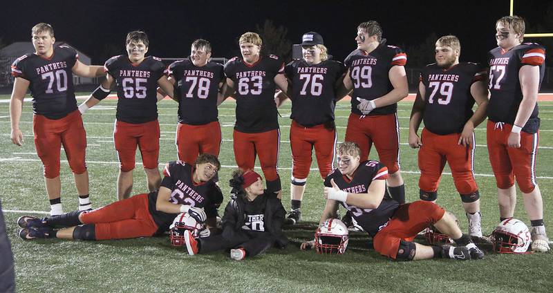 Creston offensive and defensive linemen shown after the 50-27 quarterfinal win over Webster City are, standing from left, Quenten Fuller (70), Jackson Kerr (65), Jagger Luther (78), Tom Mikkelsen (63), Gunner Martwick (76), Max Chapman (99), Wyatt Barber (79) and Lucas Rushing (57). Shown in front are Brayden Schoon (62) and Tucker Rohrig (50) with Rohrig's sister, Treva. The lines have been the unheralded foundation of Creston's success, both offensively and defensively, in the 11-0 season.
