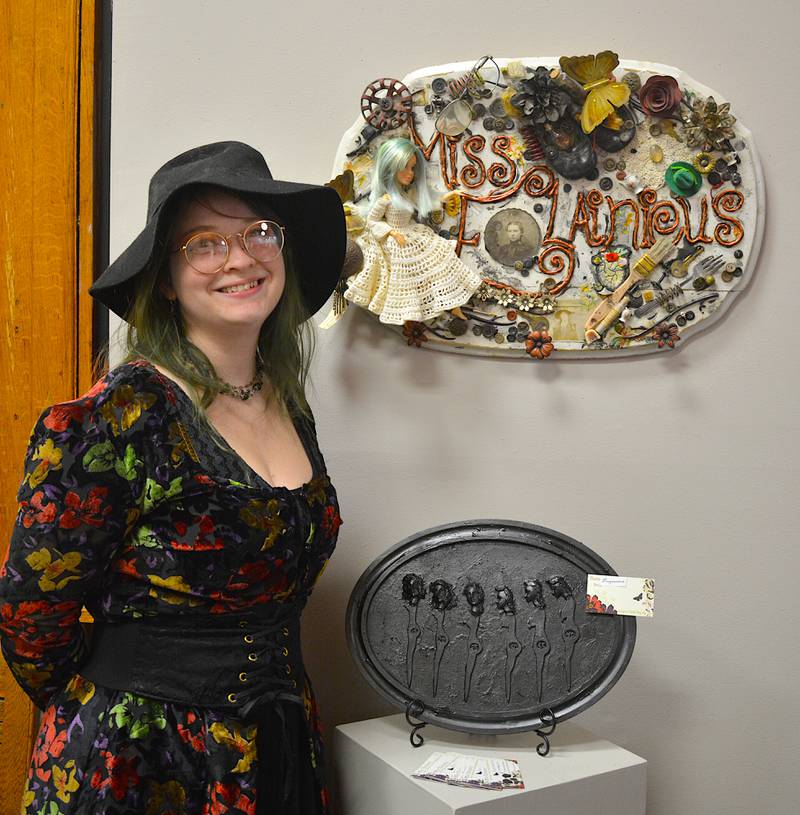 Elaina Frederickson, and two of her art pieces created under the name "Miss Elainious."