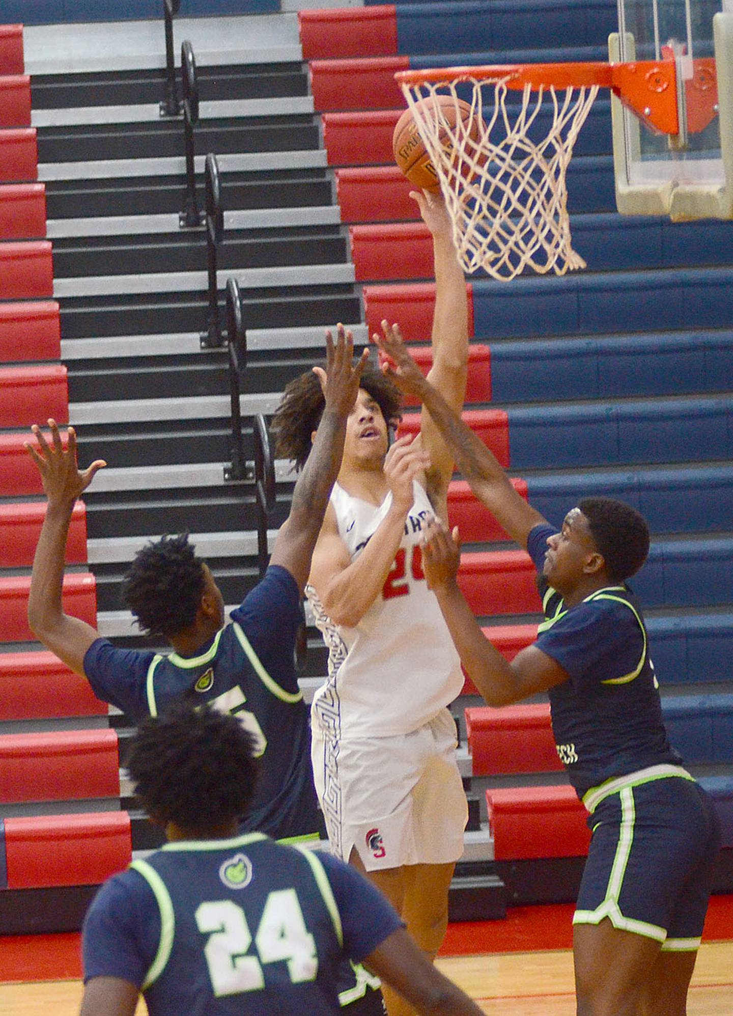 Southwestern's Andrew Scroggins puts up a shot between two defenders during Wednesday's home victory over Western Iowa Tech. Scroggins finished with 18 points and six rebounds.