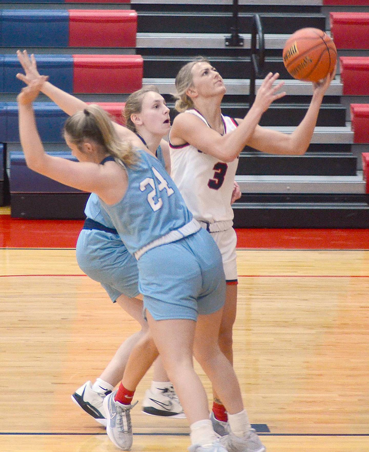 Southwestern sophomore Cassidy Nelson of Lenox drives between two Iowa Central defenders on her way to the basket. Nelson had 12 points and seven rebounds in her final home game for the Spartans.