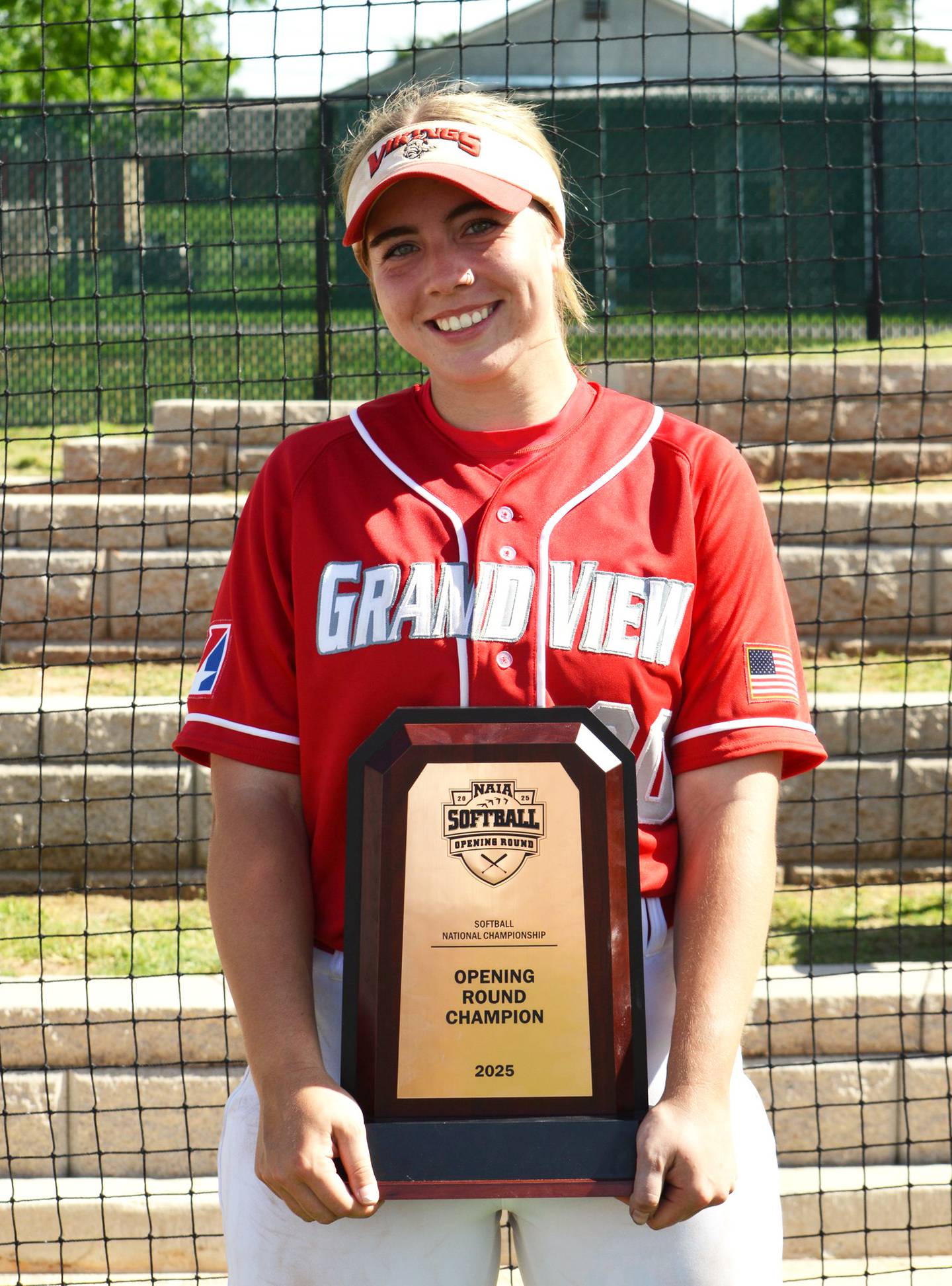 Creston 2024 graduate Nevaeh Randall holds the opening round champion plaque Wednesday after the Grand View Vikings took down the No. 1 seed to advance to the World Series.