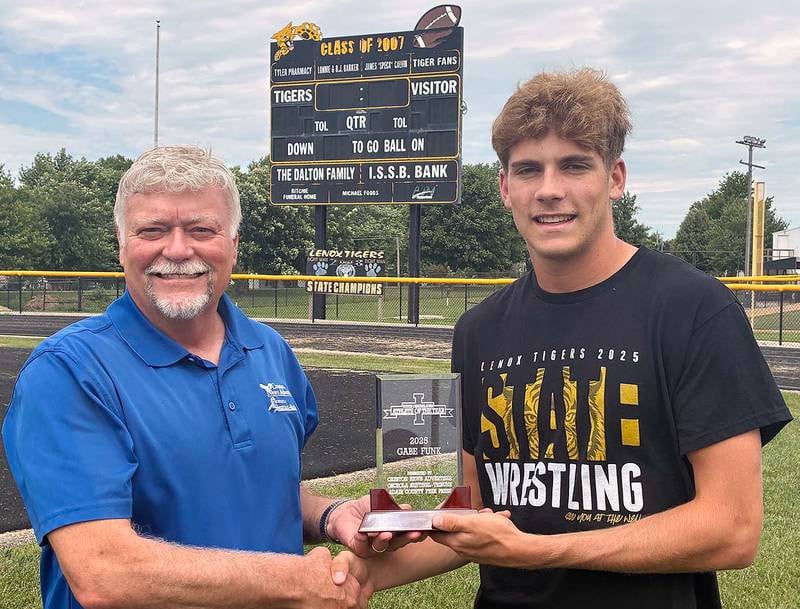 Gabe Funk of Lenox receives the 2025 South Central Iowa Male Athlete of the Year award from Larry Peterson, retired sports editor and freelance contributor to the News Advertiser sports department.