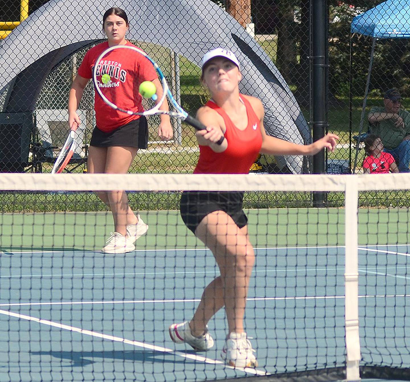 Hollynn Rieck of Creston hits a volley at the net while playing doubles with Kennedy Strider at the Hawkeye Ten tournament Wednesday.