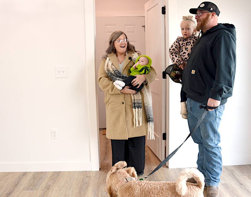 Jared and Maggie Masker, with children Maddax and Jay, and family dog Luna, react to their new home, built just for them by "One Family, One Purpose" Ministries.