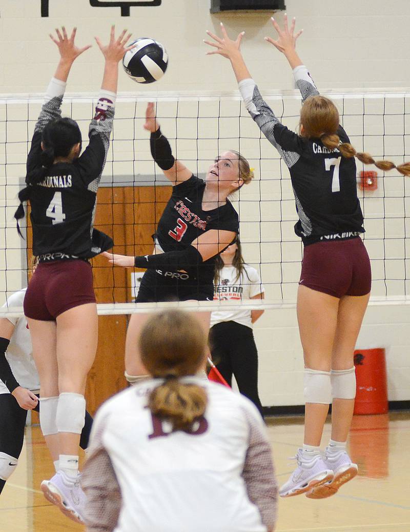 Creston's Jaycee Hanson (3) sends an attack through the block attempt of Clarinda's Kylie Meier (4) and Miley Wagoner (7). Hanson had a team-high six kills and 17 digs for the back row defense.