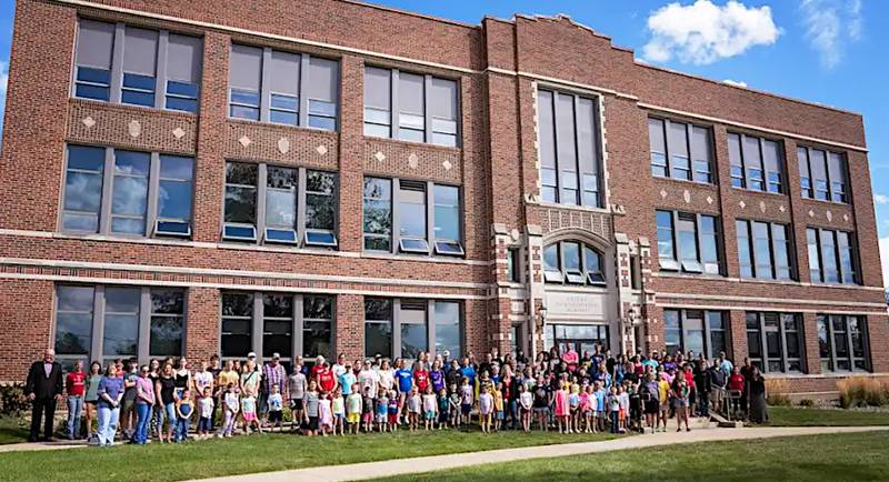 Orient-Macksburg's student body and staff stand out front of the original 1921 building, where a similar photo was taken before the building opened.