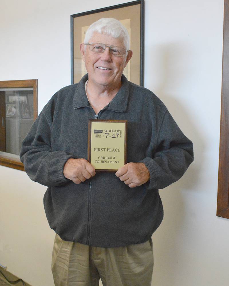 Steve Tilley holds his award for winning the Iowa State Fair's cribbage tournament.