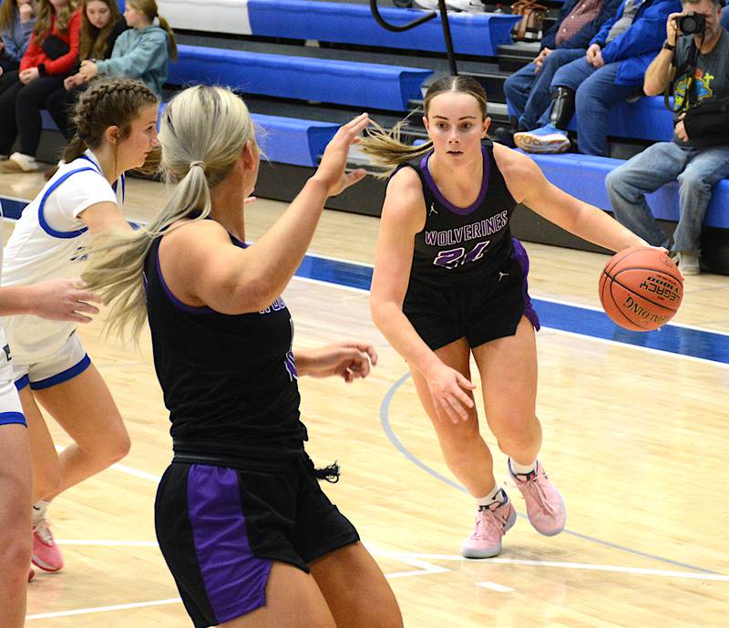 Wolverine senior Lindsey Davis drives to the basket for a waiting Annika Nelson during a game this season. Davis was named first team all-conference unanimously by the conference's coaches, Nelson is honorable mention and Izzy Eisbach also first team.