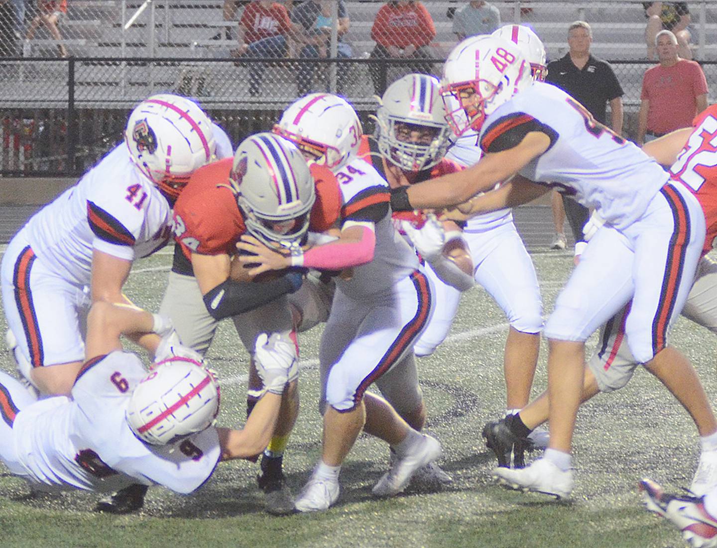 Creston defenders gang up to stop Harlan running back Ayden Redmon (34). Making the play are Tom Mikkelsen (41) and Colby Brammer (34), with help from Brodrick Phelps (9) and Ethan Holliday (48).