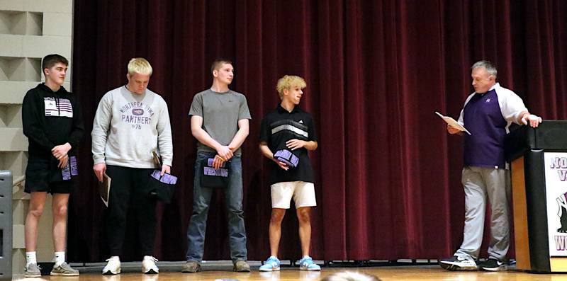 Wrestling seniors for Nodaway Valley were from left, Ty Strode, Ashton Honnold, Matthew Nelson and Keyin Steeve. They are pictured with head coach Brad Honnold during the awards portion of Sunday night's wrestling banquet.