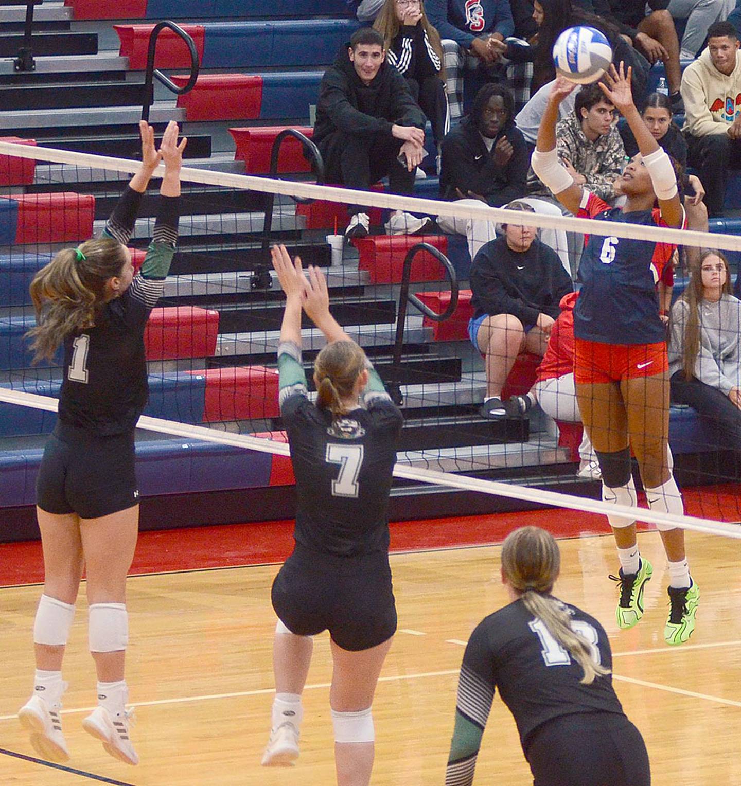 Southwestern's Skyelar Lawal looks to tip around Central blockers during Wednesday's home match.