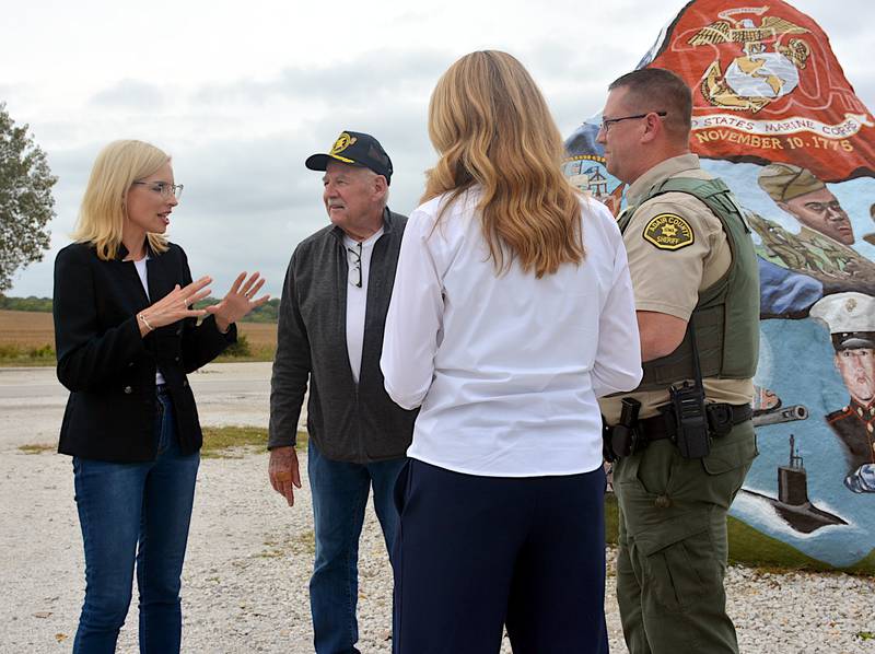 Congresswoman Ashley Hinson talks with a few select visitors to the Freedom Rock along Highway 25 north of Greenfield last Tuesday.
