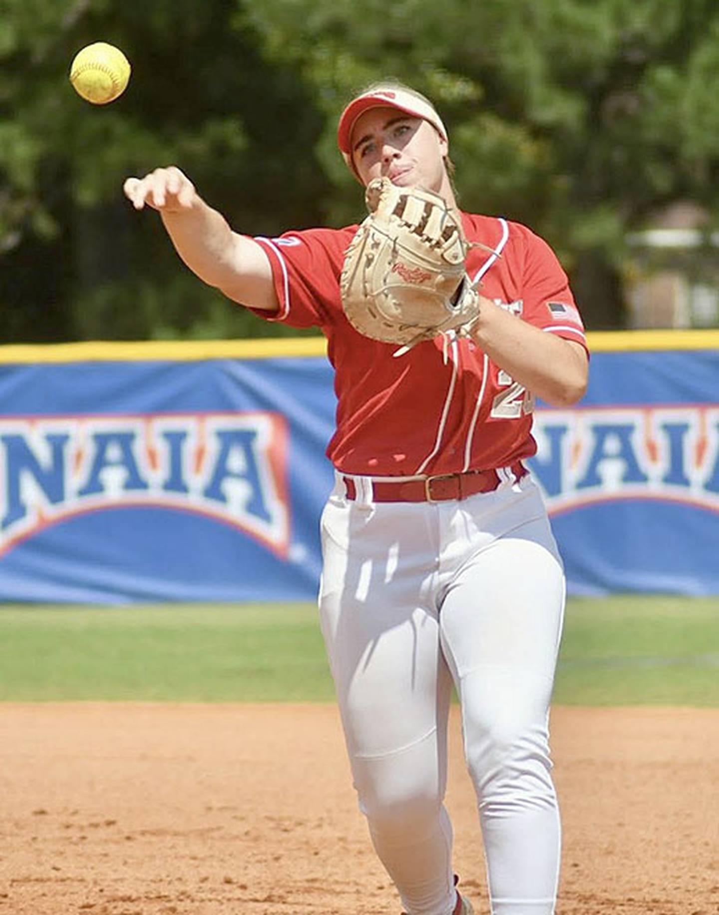 Nevaeh Randall throws to first base after fielding a ground ball during action at the NAIA Softball World Series.
