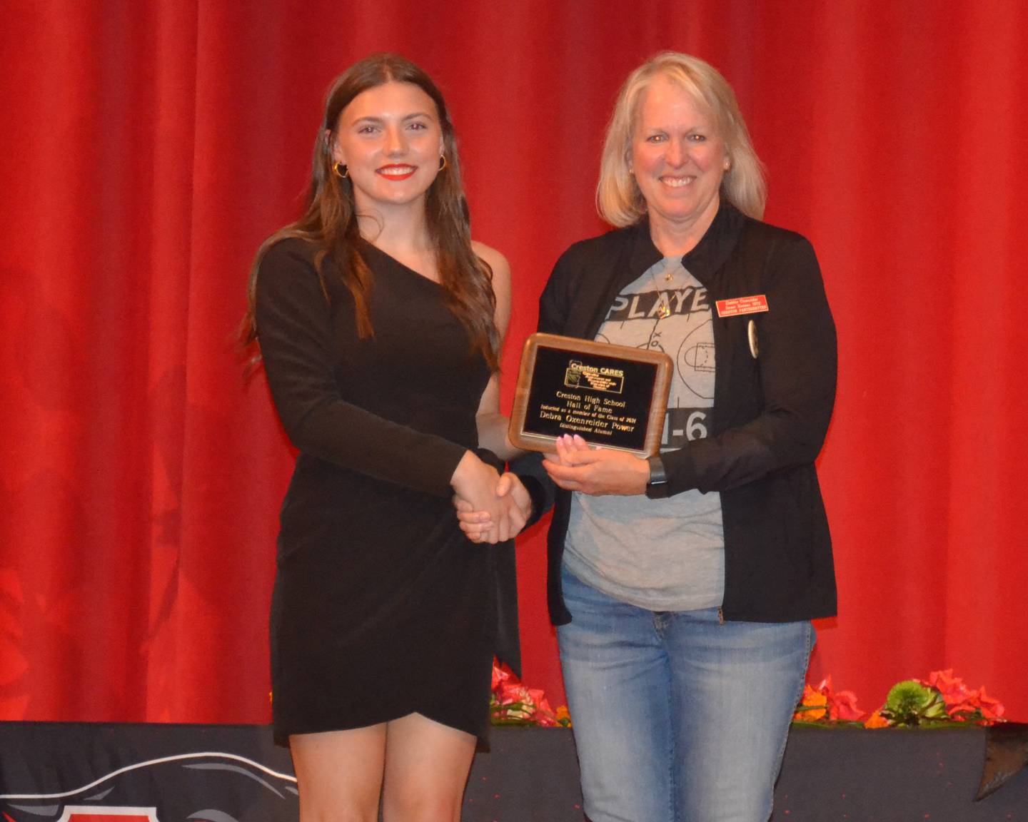 Deb (Oxenreider) Power is inducted into the Creston Hall of Fame by junior Hollynn Rieck.