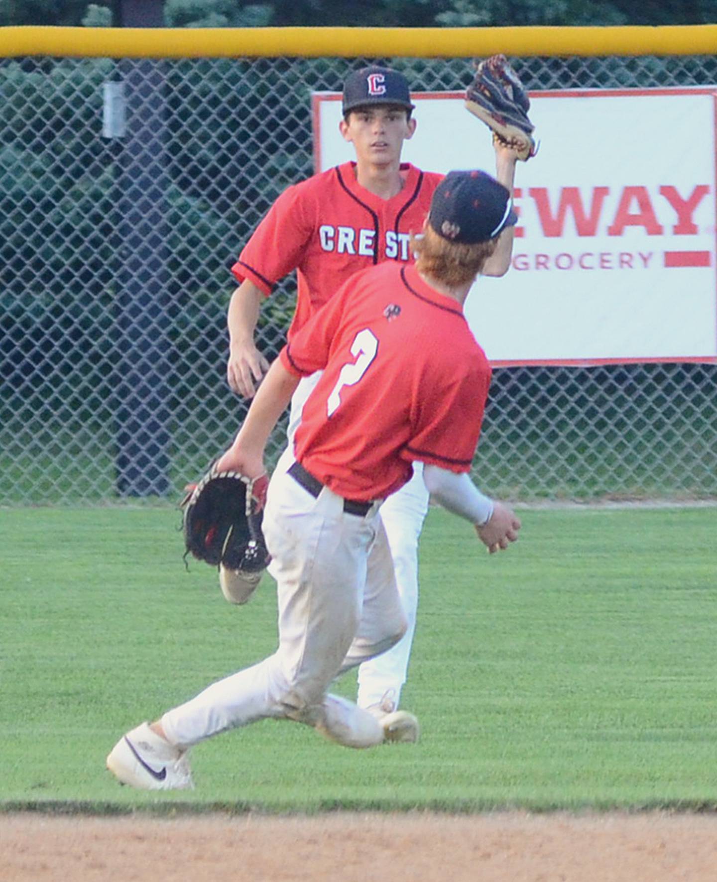 Creston senior Gavin Millslagle catches a fly ball in shallow left field as shortstop Tanner Ray (2) yields to his teammate to make the play. Ray had a single and Millslagle scored two runs in the 10-5 Creston win.