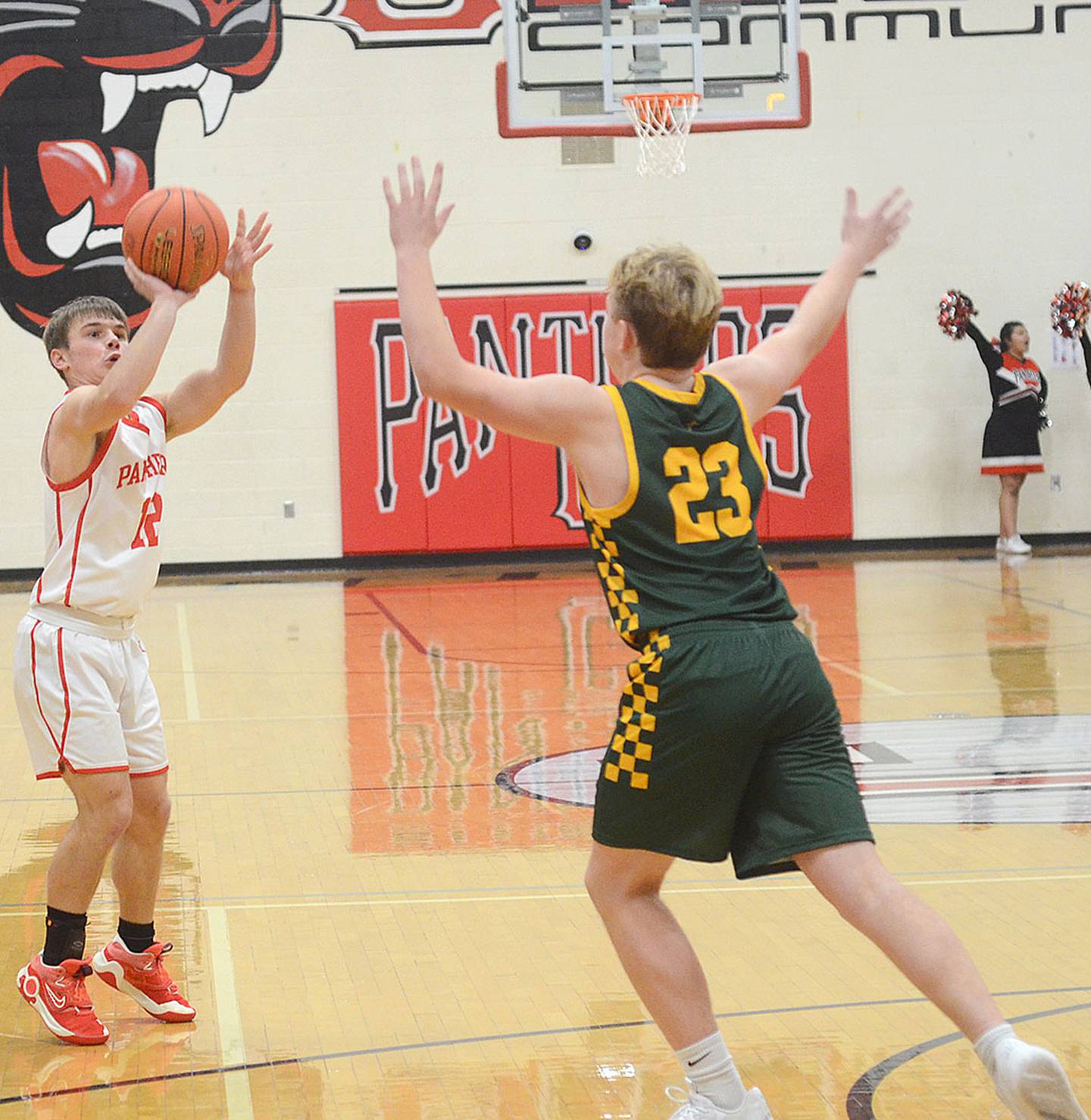 Creston guard Tyler Riley shoots a 3-pointer against St. Albert defender Noah Narmi during Tuesday's game. Riley sank one of six 3-pointers made by the Panthers in the loss.