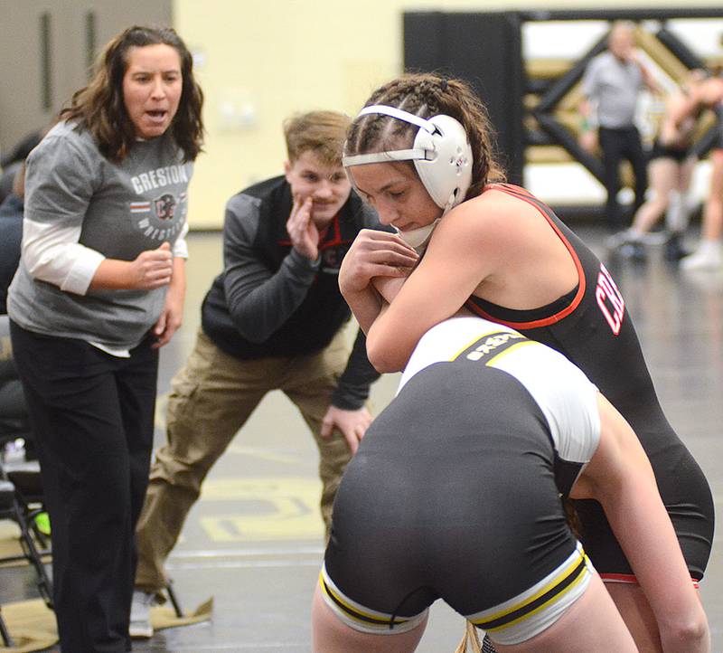 Creston coaches Maggie Arnold (left) and Trey Chesnut shout instructions to 135-pounder Grace Keeler during Keeler's semifinal victory over Malia McHugh at Friday's Class 2A regional tournament. Keeler won the weight division for a repeat trip to state.