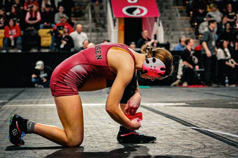 SWAT senior Jazz Christensen of Nodaway Valley fastens an ankle band prior to a match at the girls state wrestling tournament Thursday and Friday in Coralville.