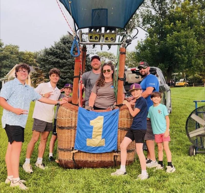 Patrick Cloyd (center) celebrates winning the National Balloon Classic with his family.