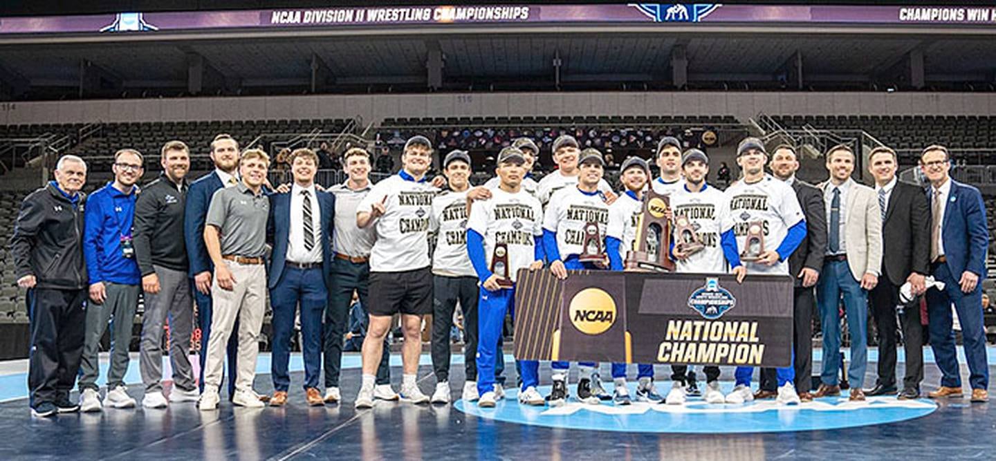 The University of Nebraska-Kearney wrestling team captured its second straight national championship and sixth in school history. Heavyweight Crew Howard of Clarinda and 197-pounder Jackson Kinsella of Creston are in the back row behind the trophy and banner.