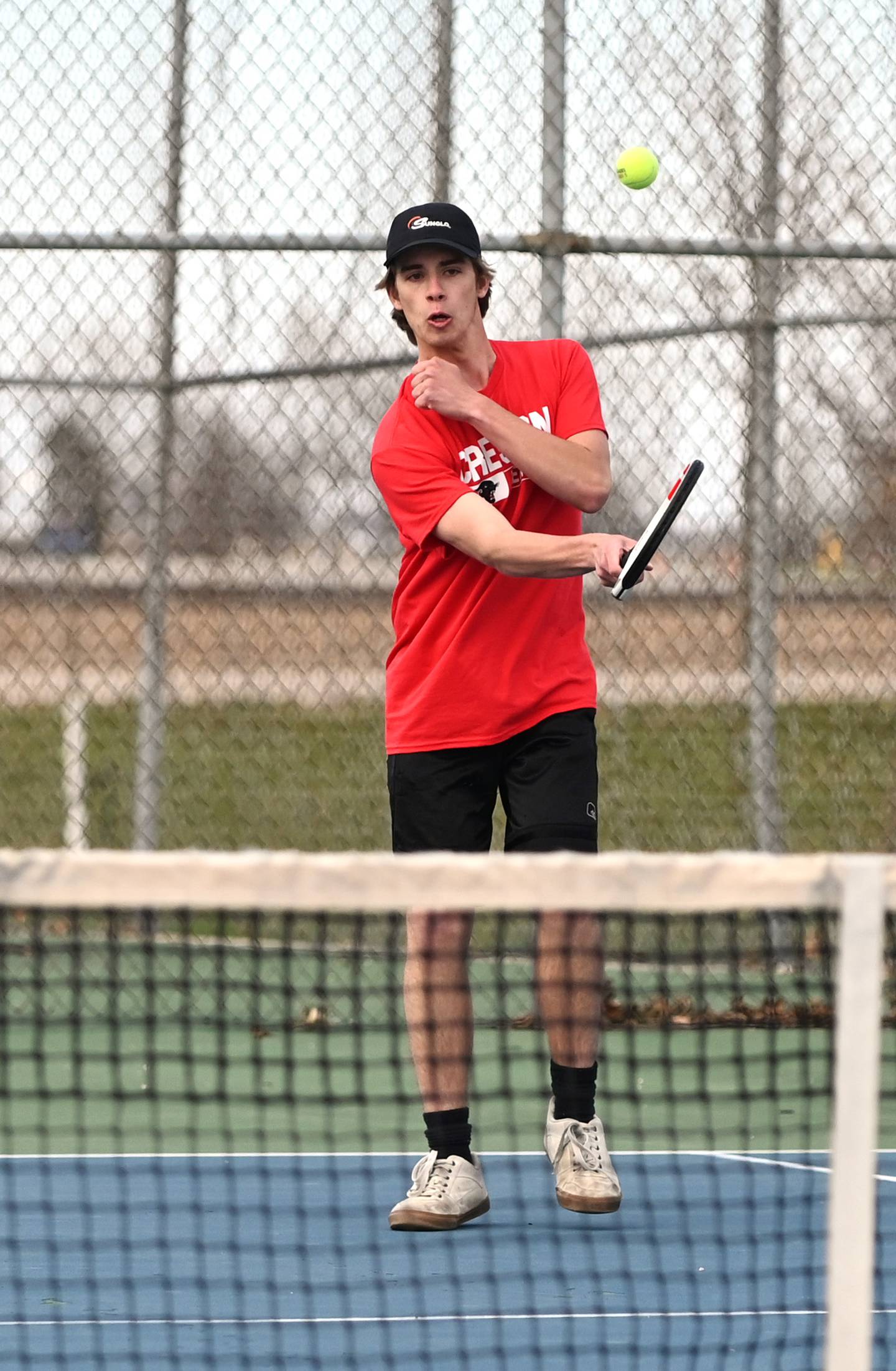 Creston senior Wyatt Hitz returns a serve in No. 1 doubles Friday. The Panther team won 8-6.