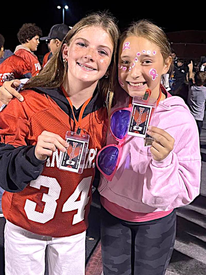 X and Y share a moment at a Creston Panther football game. The school's Very Important Panther program is to build student relationships and improve school culture.