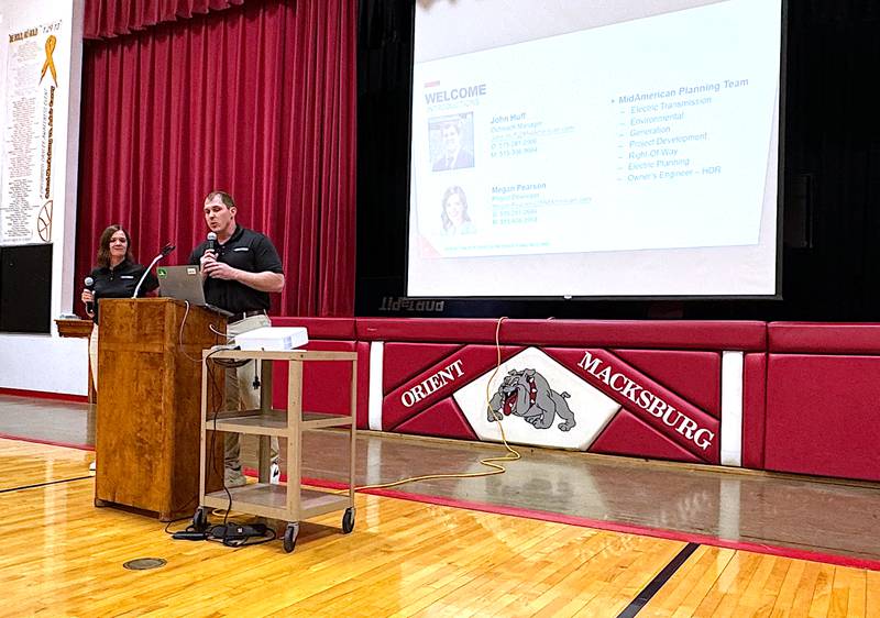 John Huff and Megan Pearson speak during a MidAmerican Energy presentation last Wednesday at the Orient-Macksburg school gym about an energy center on tap for south of Orient.